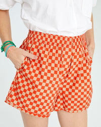 danica with her hand in the pocket of the Poppy & Khaki Checker St. Martin Shorts