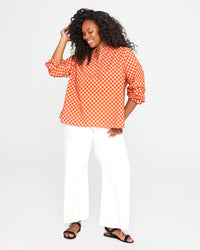 candice wearing the Poppy & Khaki Checker St. Martin Top with white pants
