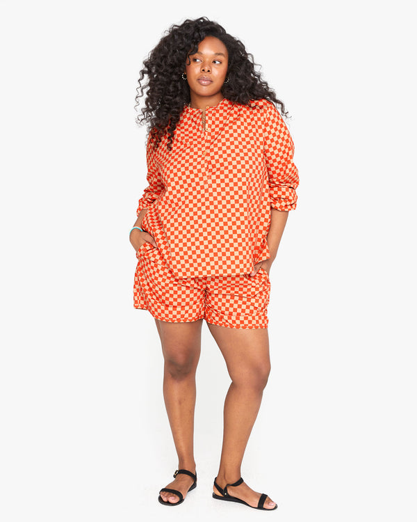 candice wearing the Poppy & Khaki Checker St. Martin Shorts with the Poppy & Khaki Checker St. Martin Blouse untucked