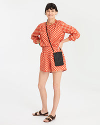danica in the Poppy & Khaki Checker St. Martin Shorts with the Poppy & Khaki Checker St. Martin Blouse and the black rattan poche