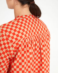 back view of danica wearing the Poppy & Khaki Checker St. Martin Top