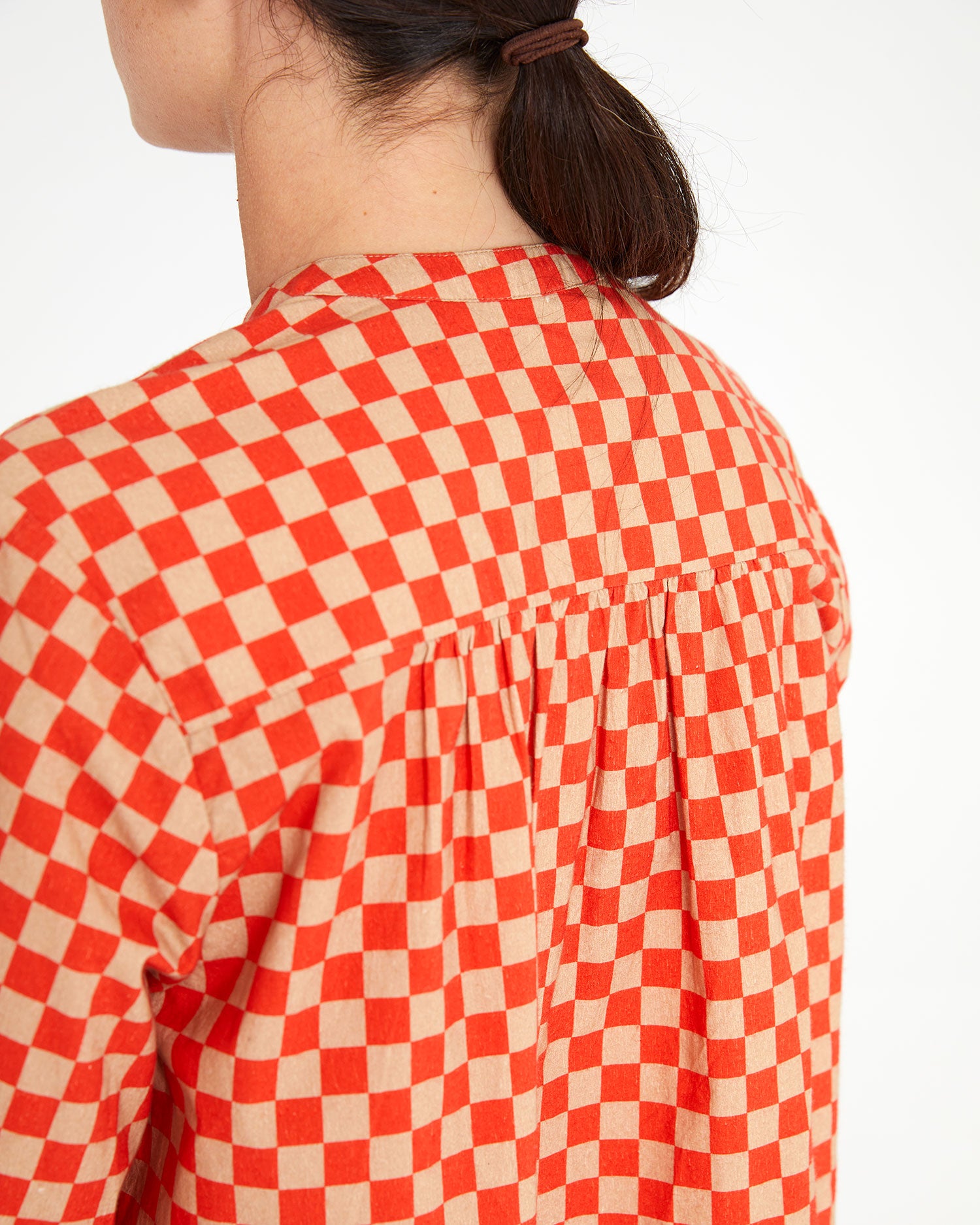 back view of danica wearing the Poppy & Khaki Checker St. Martin Top