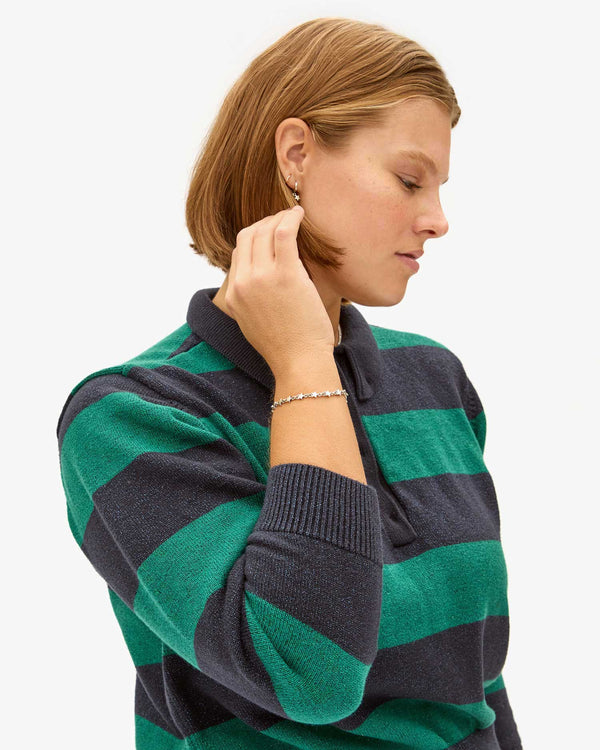 Sonnie wearing the Sterling Silver Star Strand Bracelet with the Heloise Polo