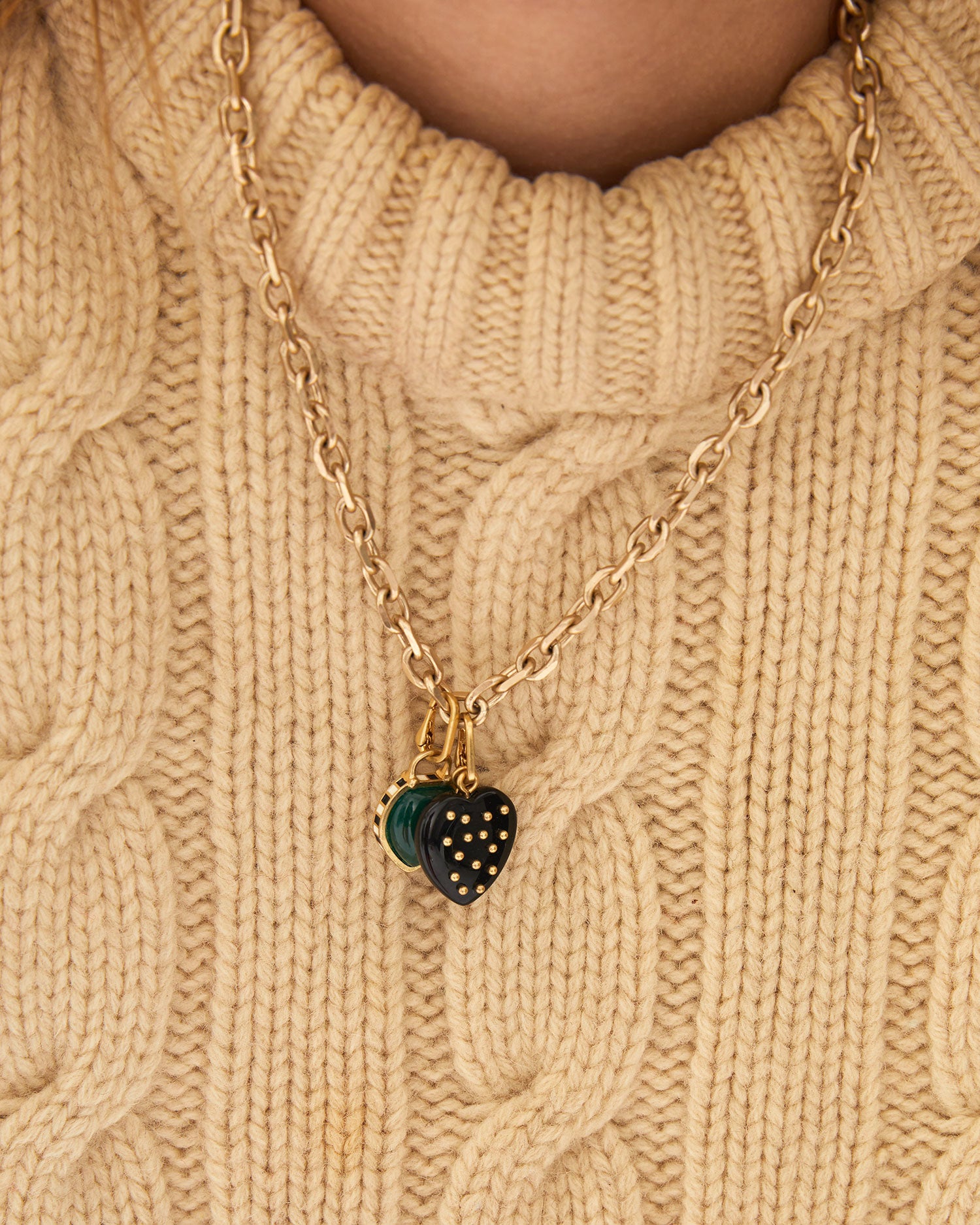 Aurelia wearing the Black Onyx Studded Stone Heart Charm on the charm chain necklace with another CV charm