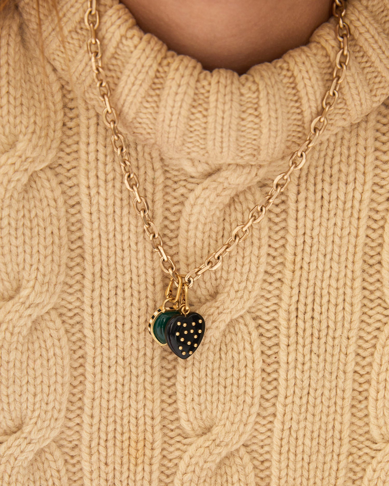 Aurelia wearing the charm chain necklace with the Emerald Stone Padlock Charm and another CV charm