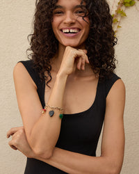 Haro wearing the Black Onyx Studded Stone Heart Charm on the charm chain bracelet