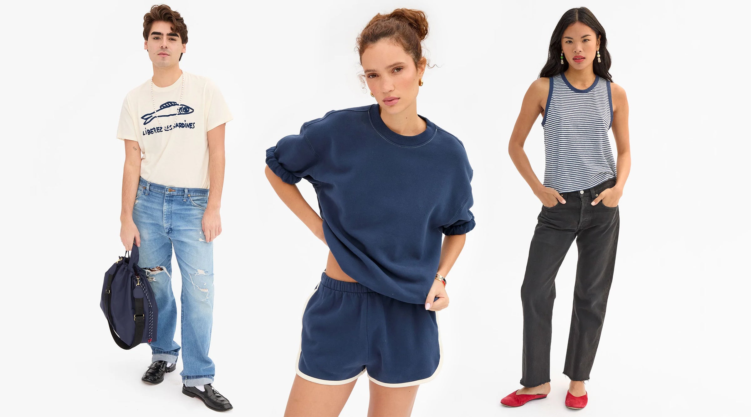 Three models wearing an assortment of Clare V. apparel. Items featured are: Navy Short Sleeve Oversized Sweatshirt, Navy Le Jogging Short, Cream w/ Navy Liberez Les Sardines Classic Tee, Navy with Cream Camp Fit Tank. 