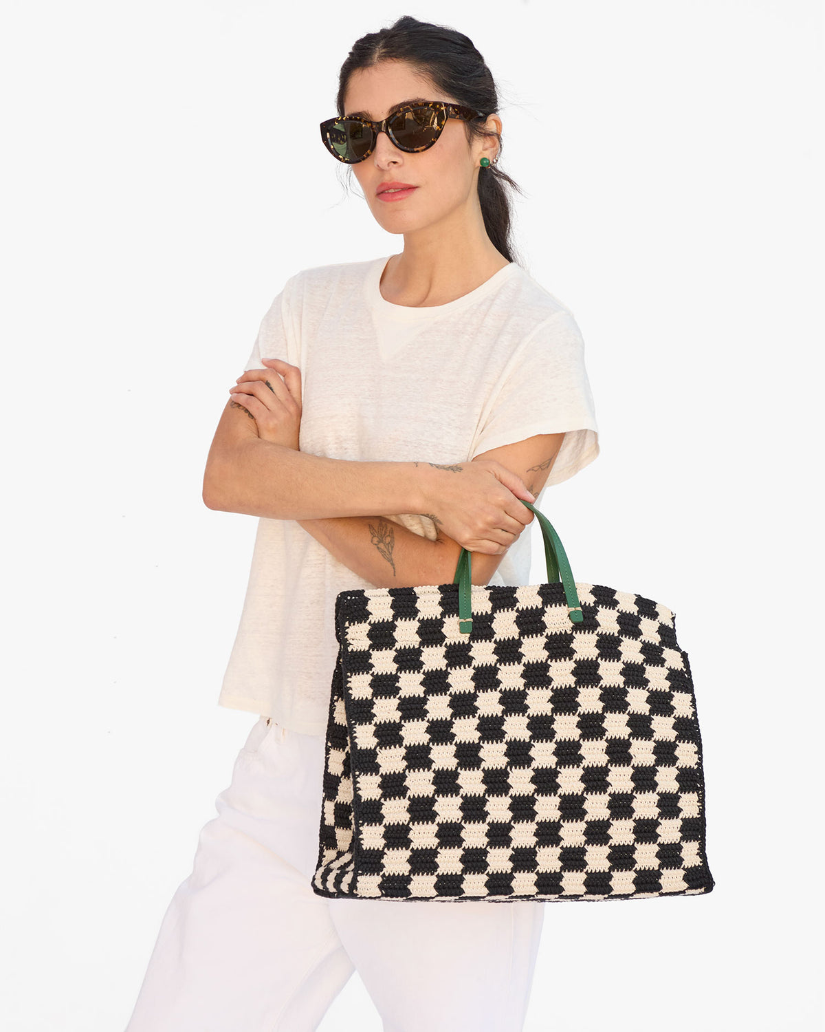 Gia holds the Black & Cream Crochet Checkers Summer Simple Tote by the Top Handle