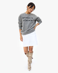 Maly wearing the Masculin Féminin Sweatshirt with a White Skirt and Leopard Boots
