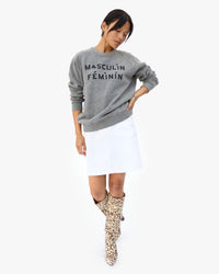 Maly wearing the Masculin Féminin Sweatshirt with a White Skirt and Leopard Boots