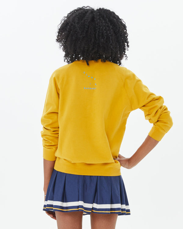 back view of mecca in the Marigold w/ Passer le Filet Sweatshirt