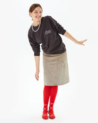 Zoe wearing the Cocoa Oui Sweatshirt with a suede skirt and red tights