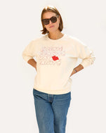 Sonnie wearing the Cream w/ Liberté Ègalité Maternité Sweatshirt with jeans