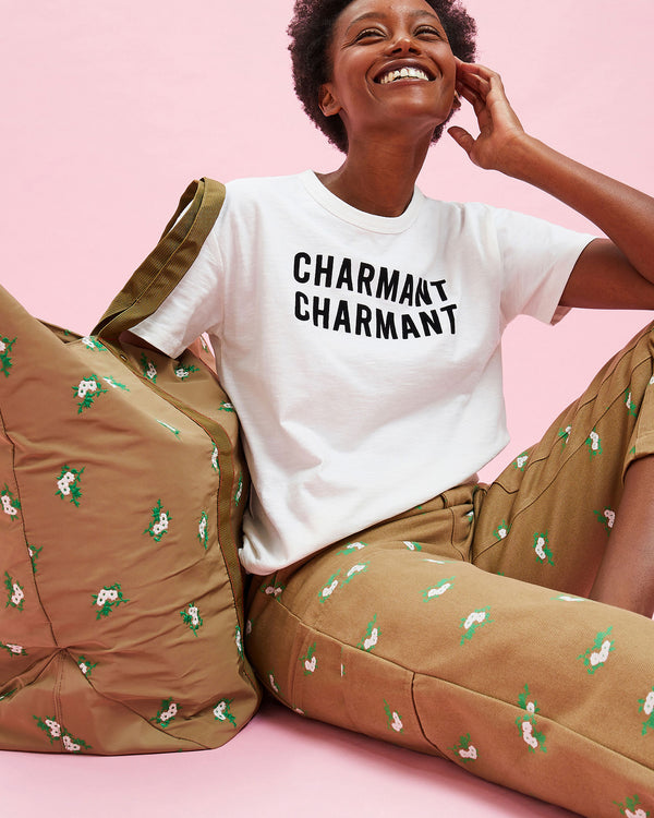Model wearing the Cream w/ Black Charmant Tee with the Cargo Pants