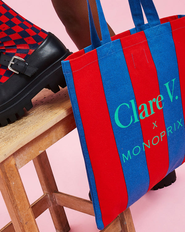 Model holding the Cobalt & Poppy Tote  by her stool