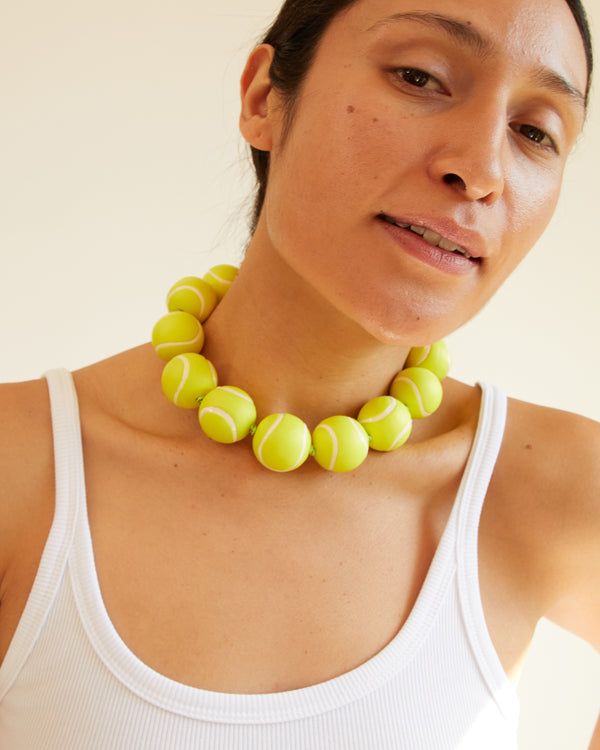 andrea wearing the Neon Yellow Tennis Ball Collar with her head tilted to the side