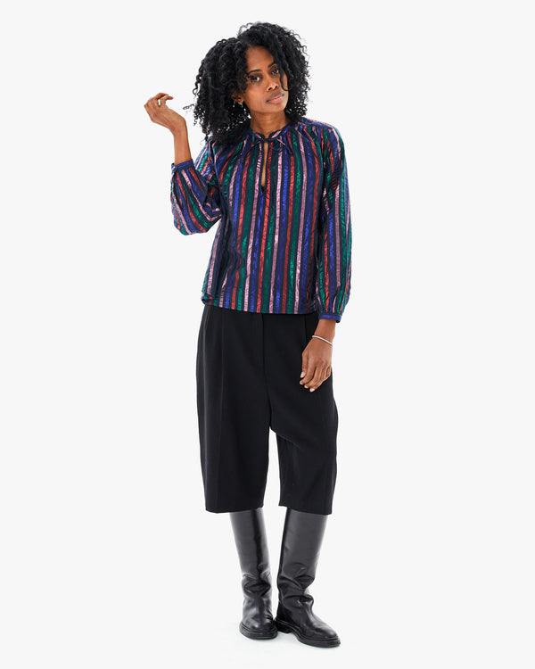 Mecca wearing the Multi Stripe Thea Blouse with capris and riding boots