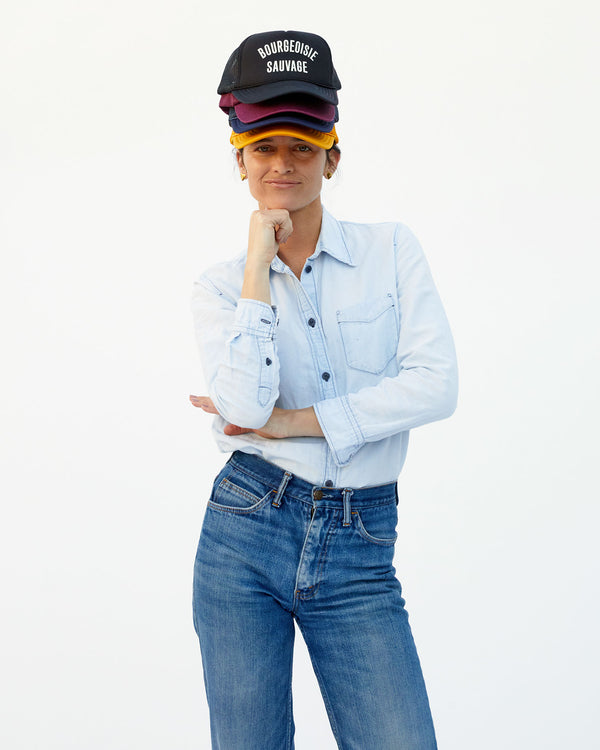 Danica wearing a stack of hats with the Black Bourgeoisie Sauvage Trucker Hat on top