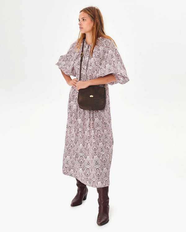 Aurelia wearing the Chocolate Suede Turnlock Louis crossbody over a long floral dress with brown boots