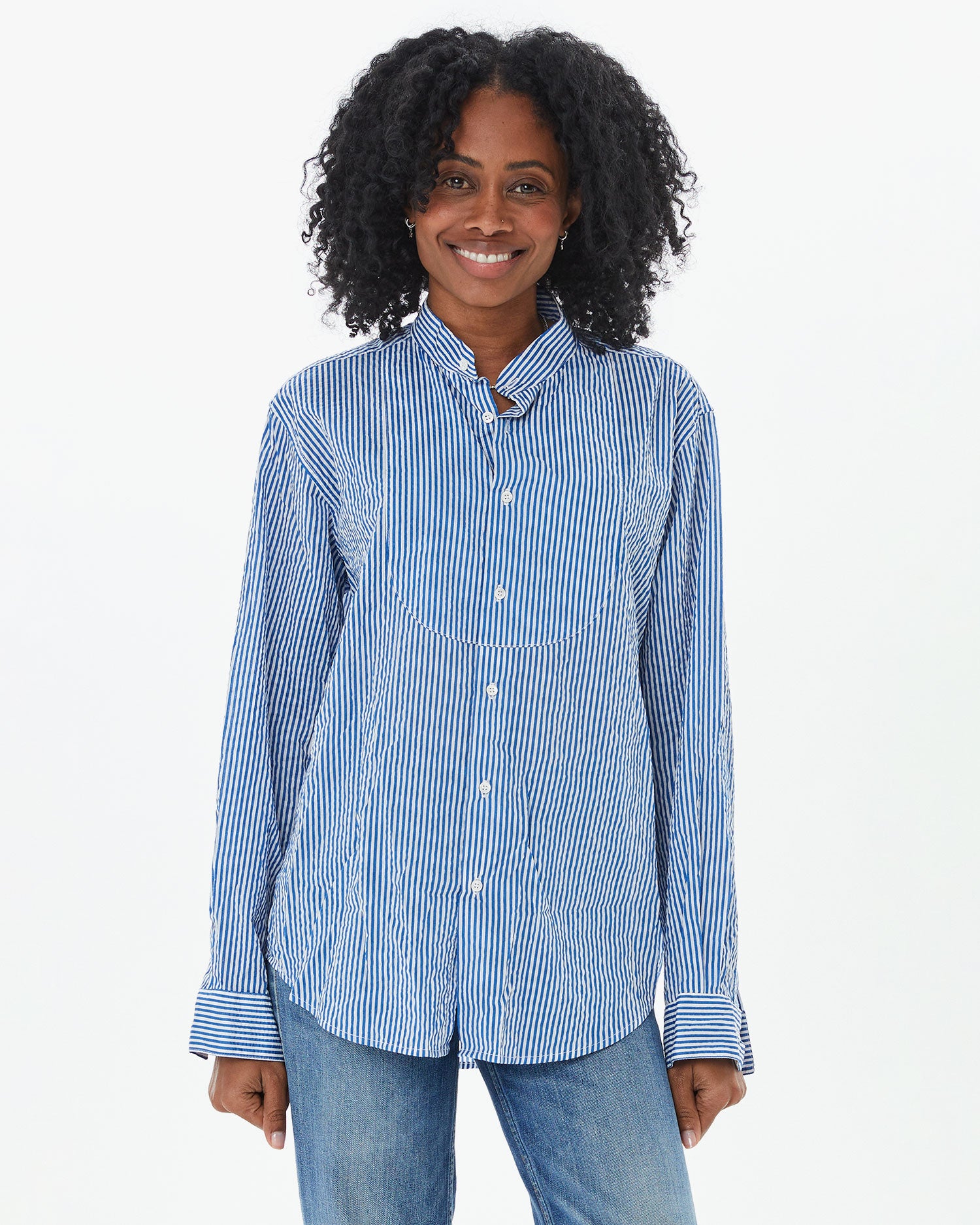 Mecca with the sleeves rolled down on the Steven Alan Tux Shirt In Blue and Cream Stripe