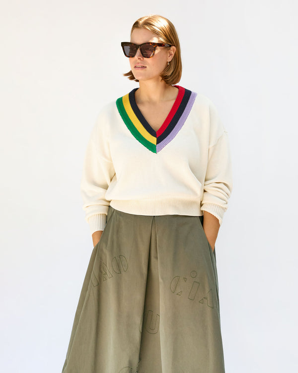 Sonnie wearing the  Olive Quilted Anais Midi Skirt  with the varsity sweater and the tortoise heather sunglasses