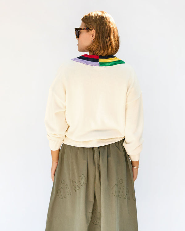 back view of Sonnie wearing the Cream w/ Multi Stripe Varsity Sweater
