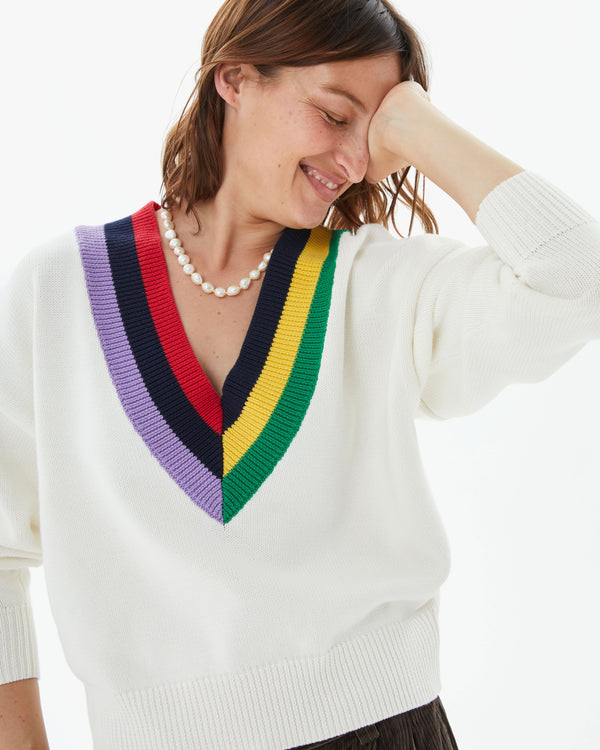 Zoe wearing the Cream w/ Multi Stripe Varsity Sweater with the sleeves pushed up her arms
