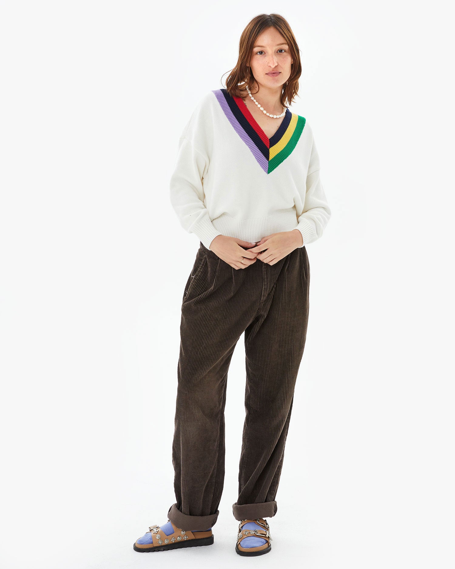 Zoe wearing the Cream w/ Multi Stripe Varsity Sweater with brown cords