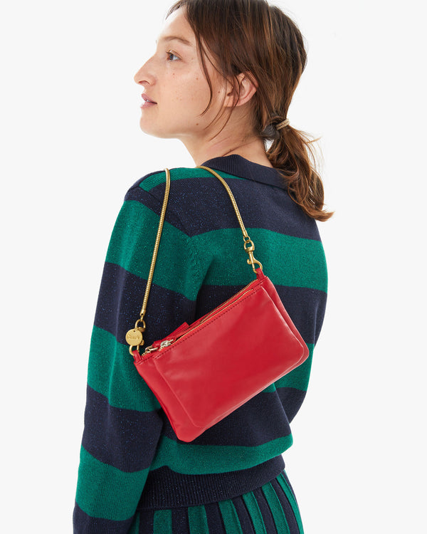 Zoe holding the Rouge Wallet Clutch Plus  over her shoulder by the vintage gold snake chain shoulder strap