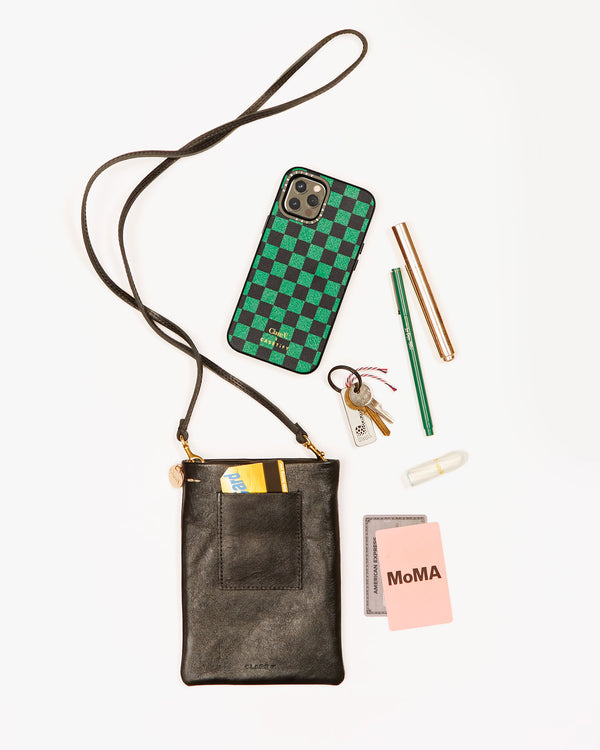 black poche with a selection of items that fit inside