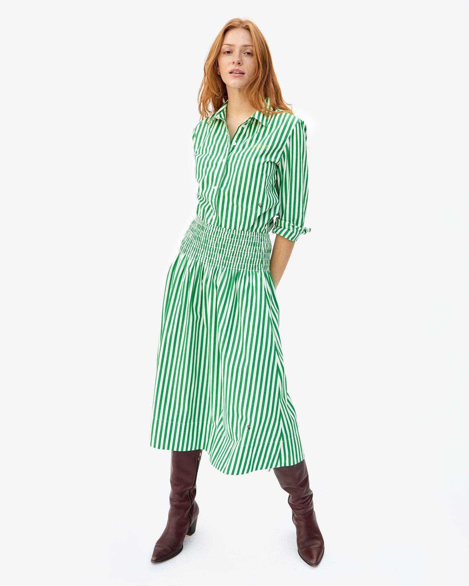 haley with her hands behind her waist. shes wearing the Green & Cream Stripe zoe skirt