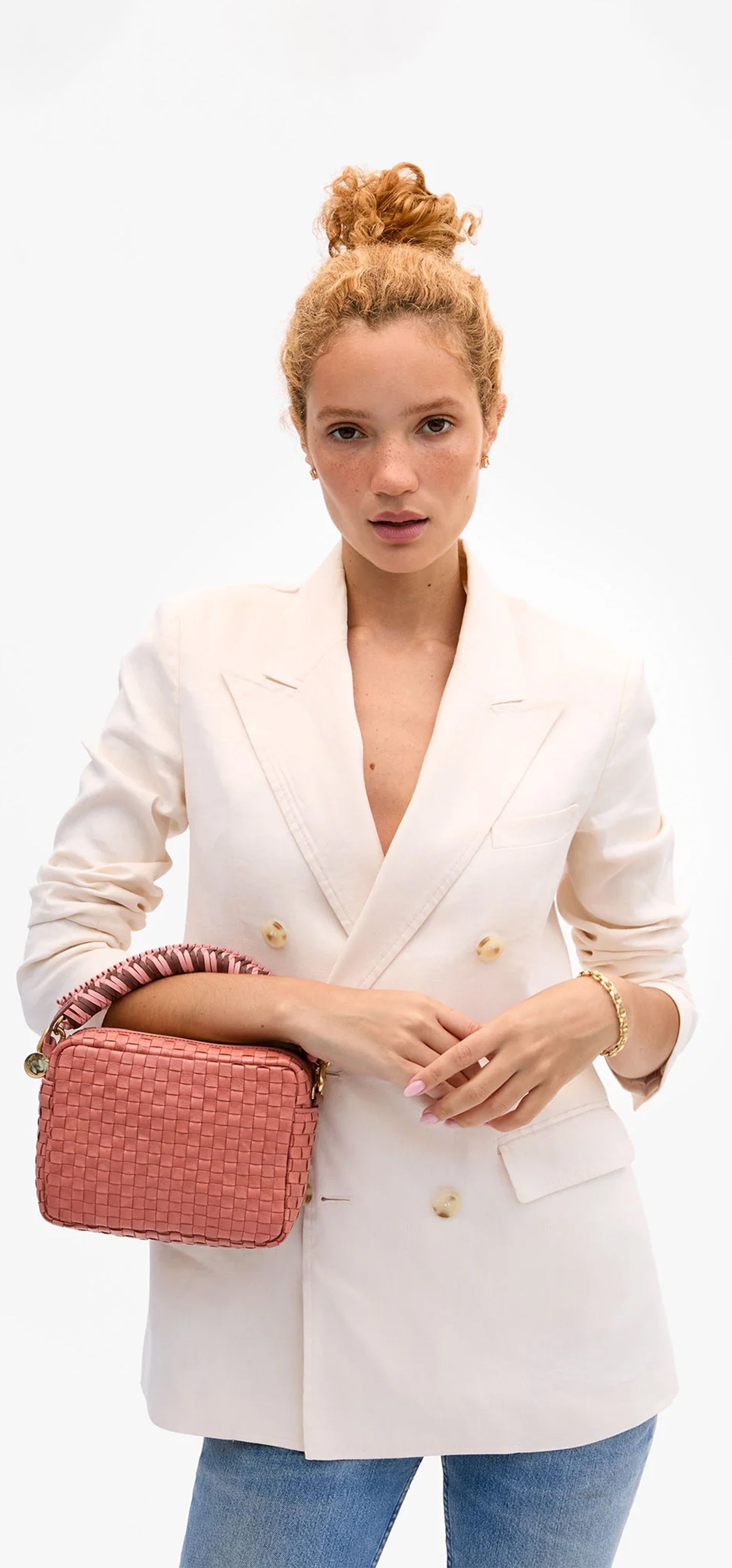 Model carrying a midi sac with the Braided Top Handle.