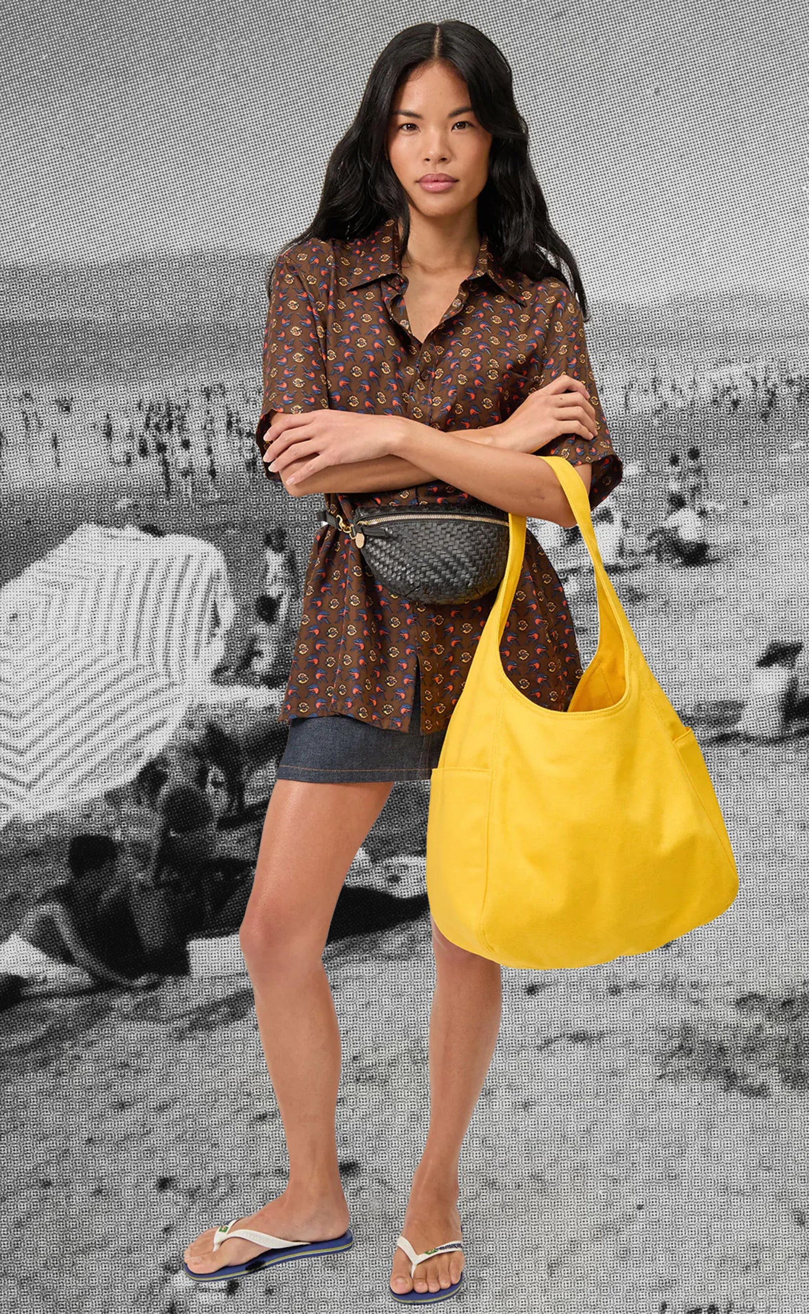 Model carrying the Snapdragon Canvas Grand Bateau and wearing the Petite Fanny in Black Zig Zag around her waist. 