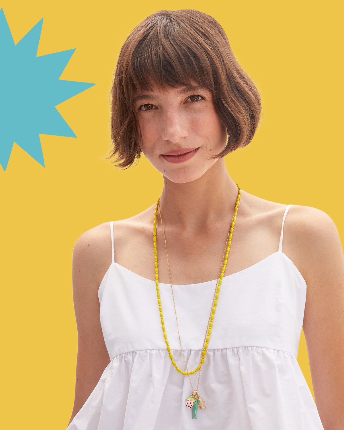 Model wearing the Yellow Enamel Bead Necklace and Vintage Gold Rolo Necklace with charms attached to it.