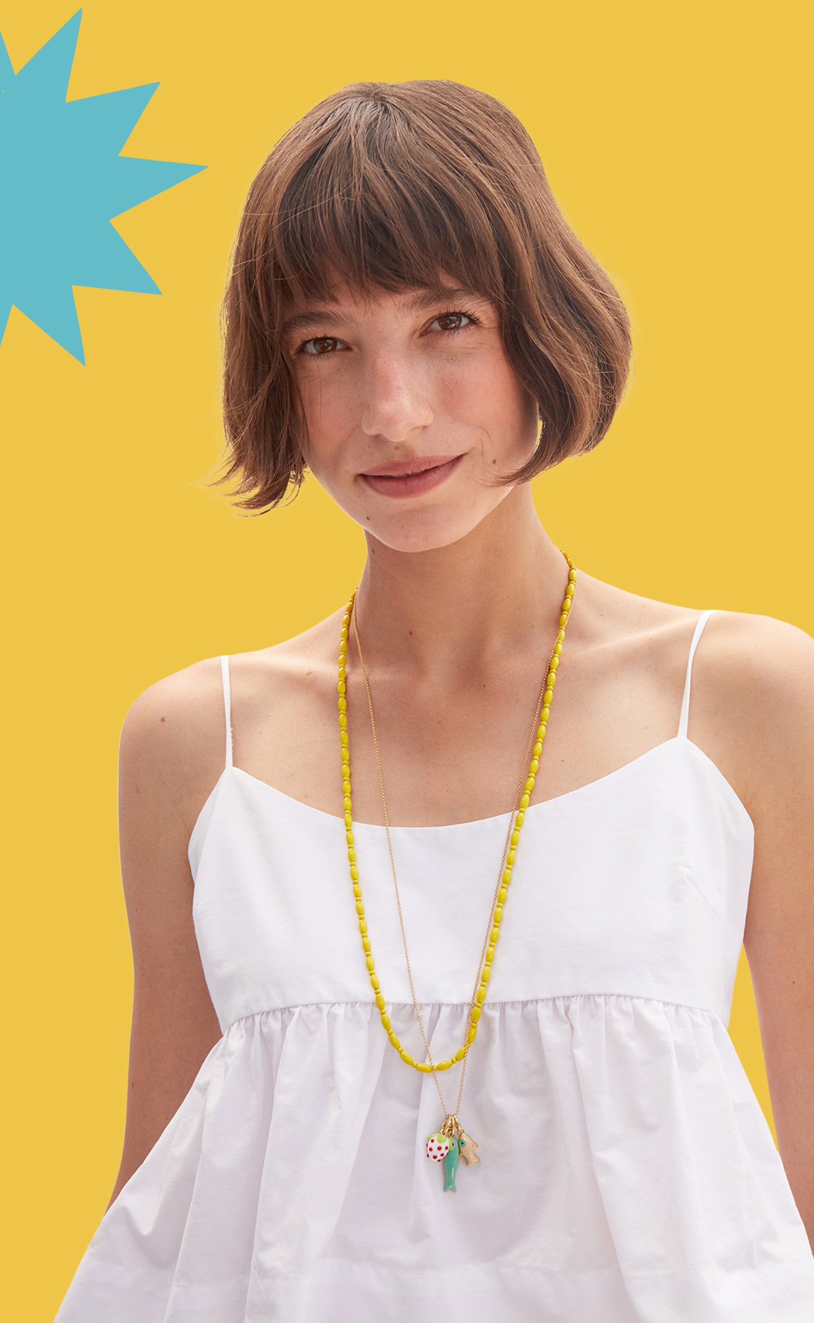 Model wearing the Yellow Enamel Bead Necklace and Vintage Gold Rolo Necklace with charms attached to it.