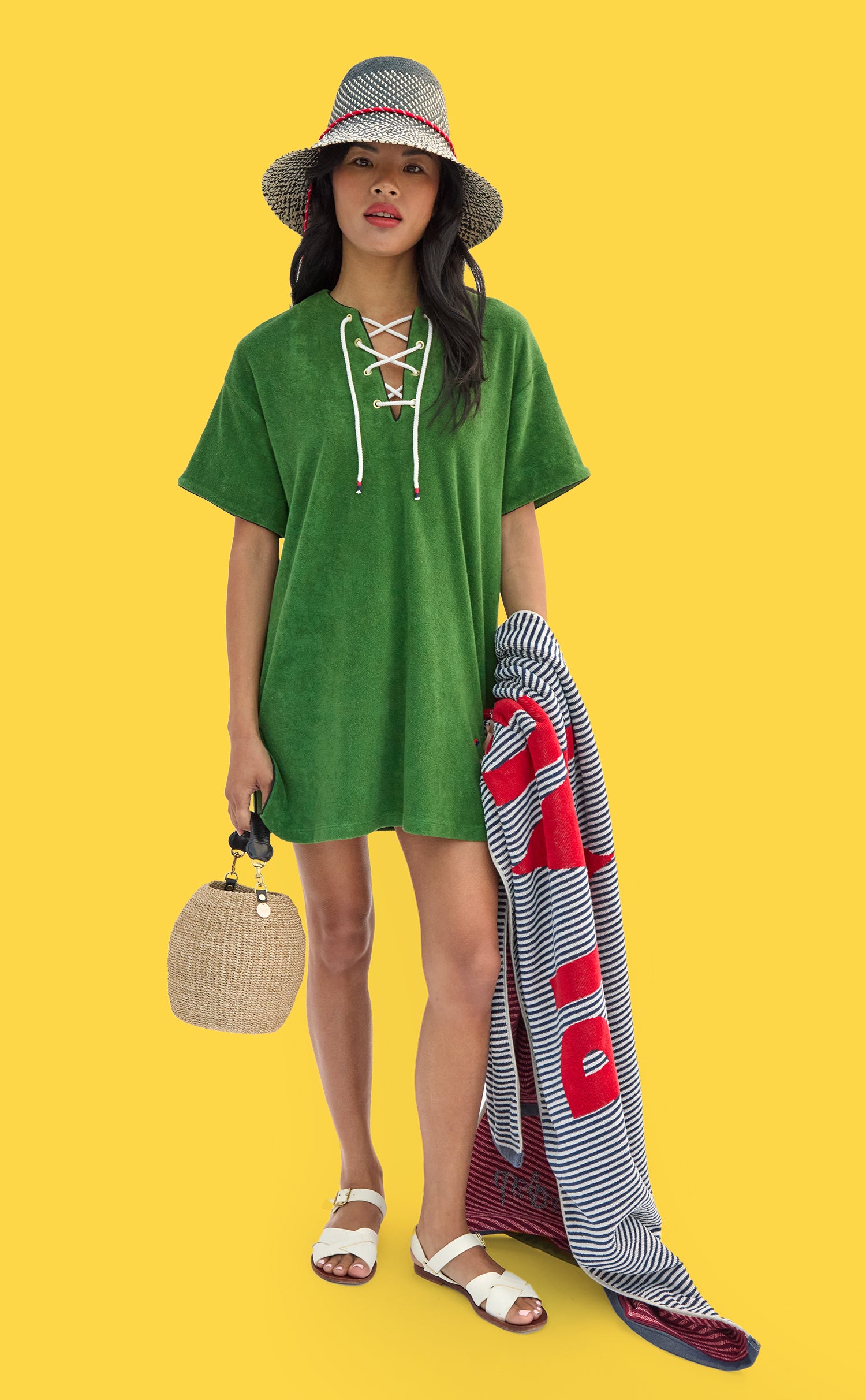 Model wearing La Plage Dress and Romy Hat while carrying Le Towel and Cream Pot de Miel.