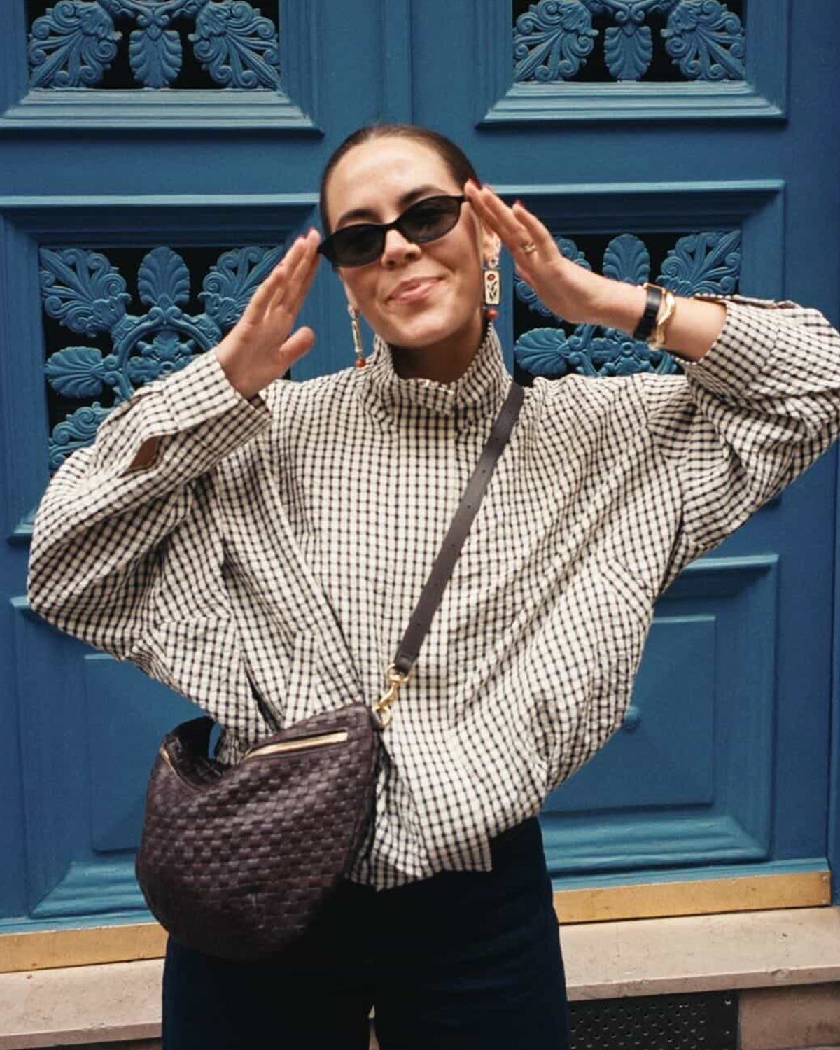 Model wearing sunglasses and carrying a Grande Fanny as a crossbody bag.