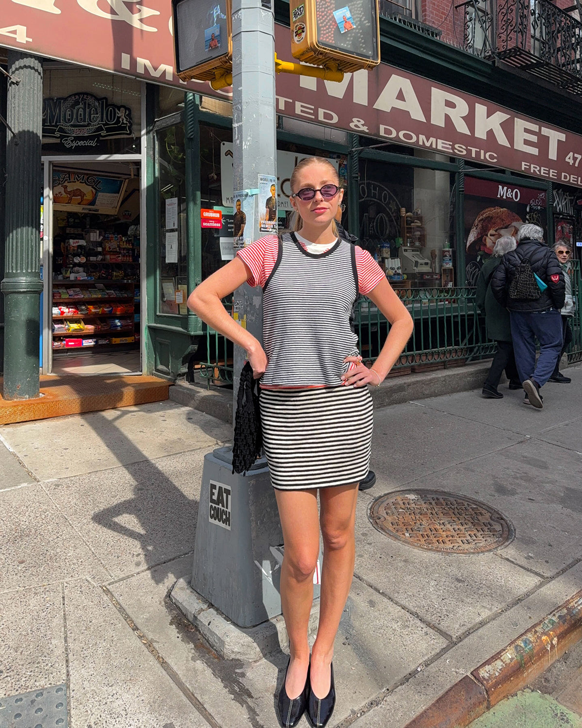 Woman wearing the Le Mini Tube Skirt, Black and Cream Mini Stipe Camp Fit Tank, Bright Poppy and Cream Mini Stripe Classic Tee.