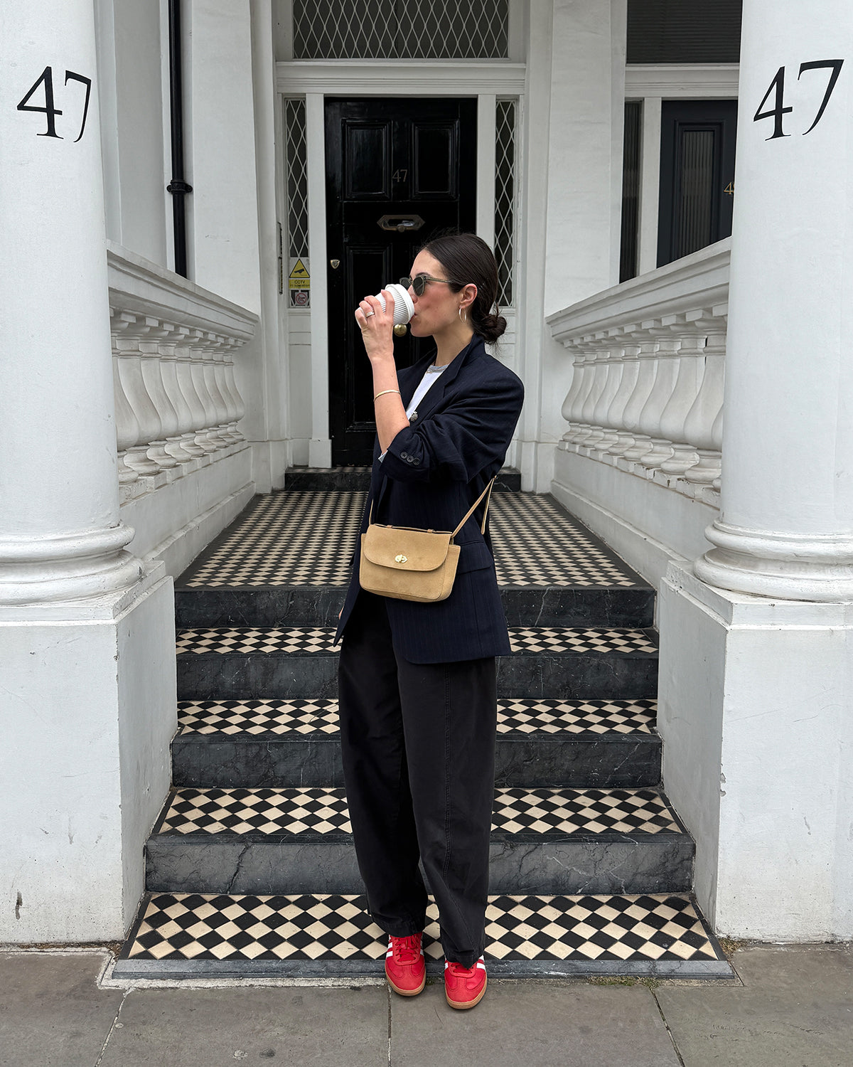 Woman carrying the Dune Suede Kathryn.