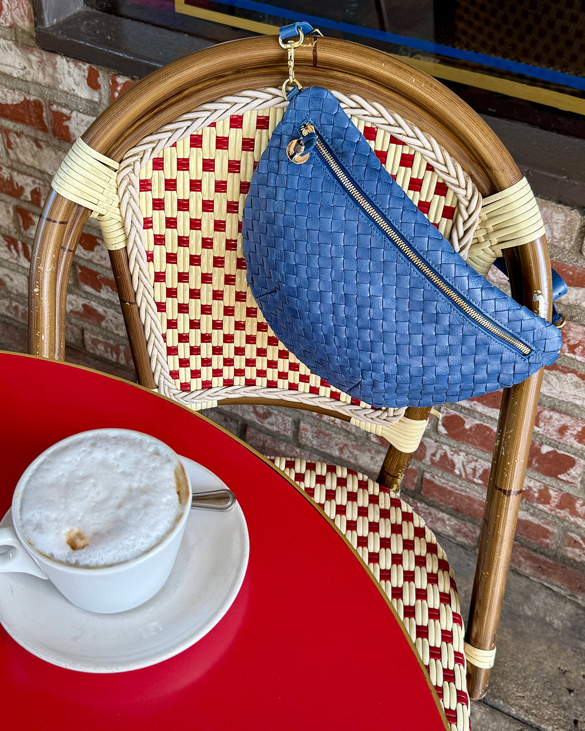 French Blue Grande Fanny on a beautiful woven chair in a cafe.