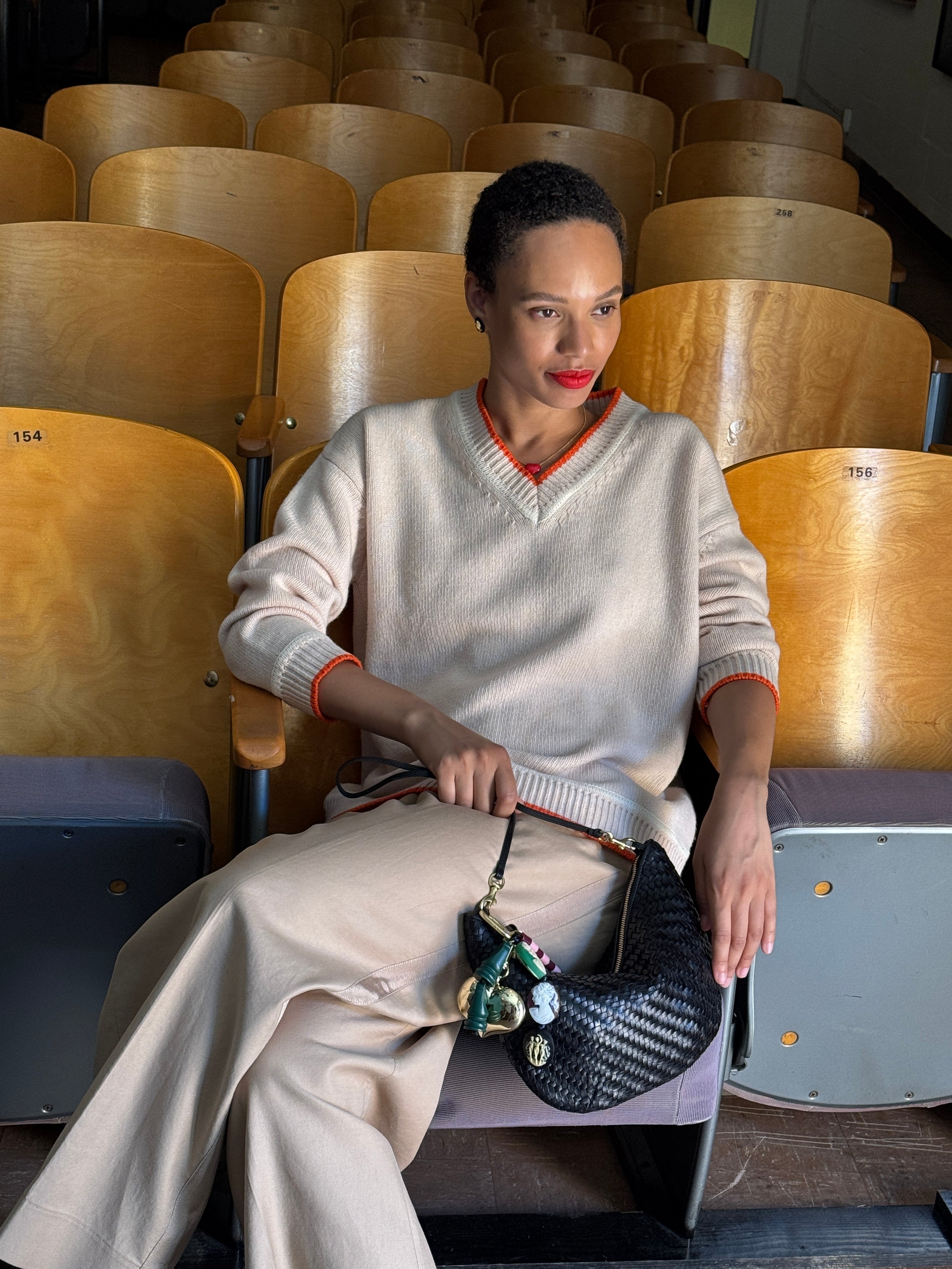 Model carrying the Black Woven Zig Zag Lune with the Multi Cameo Fob attached.