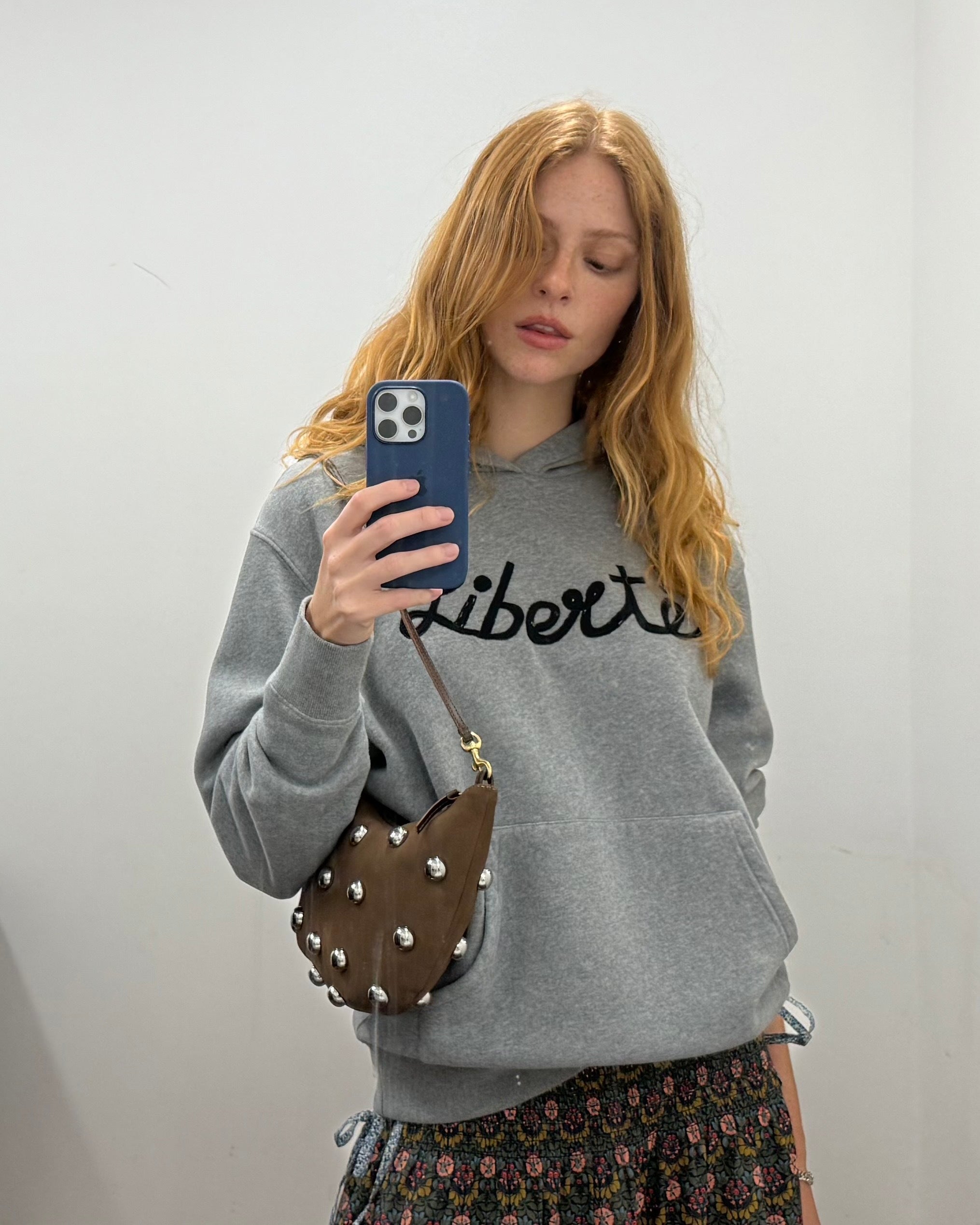 Model carrying the Lune in Choco Bar with Studs.