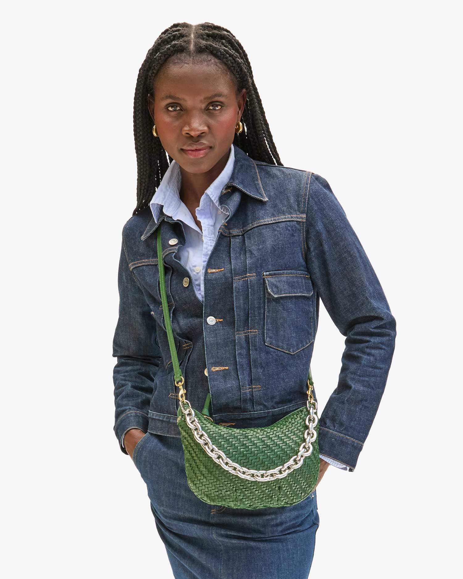 Model carrying the Evergreen Woven Petit Moyen as a crossbody bag. 