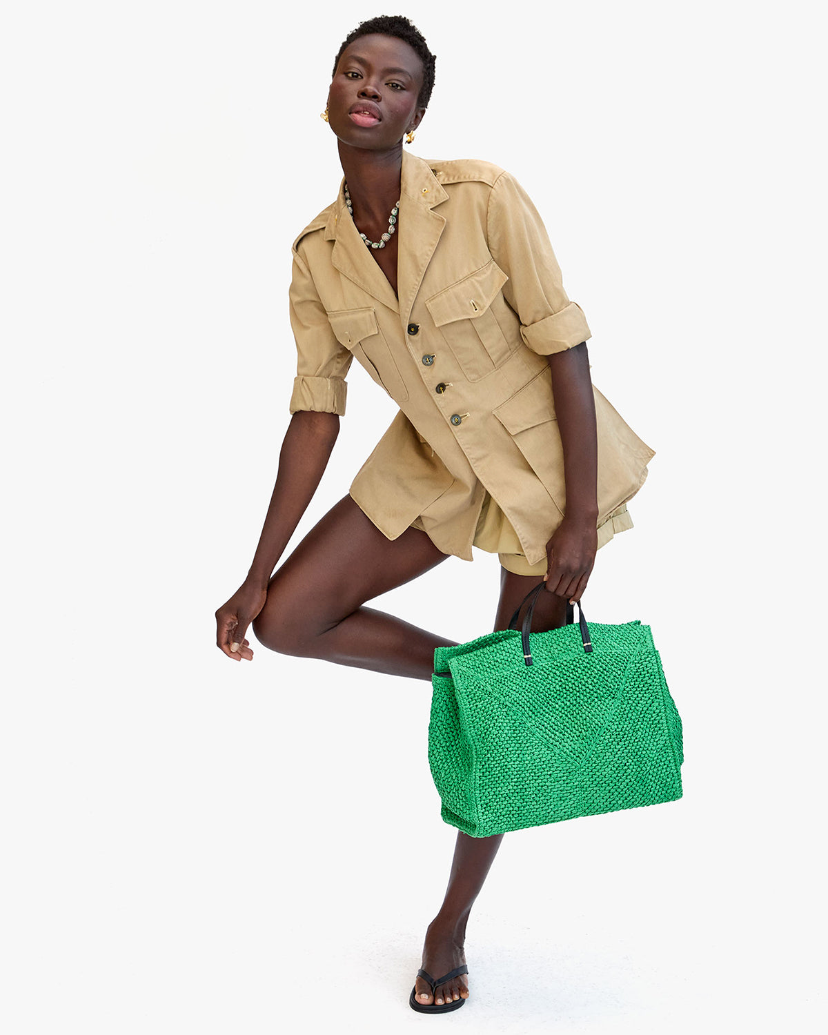 Model carrying the Green Raffia Simple Tote.