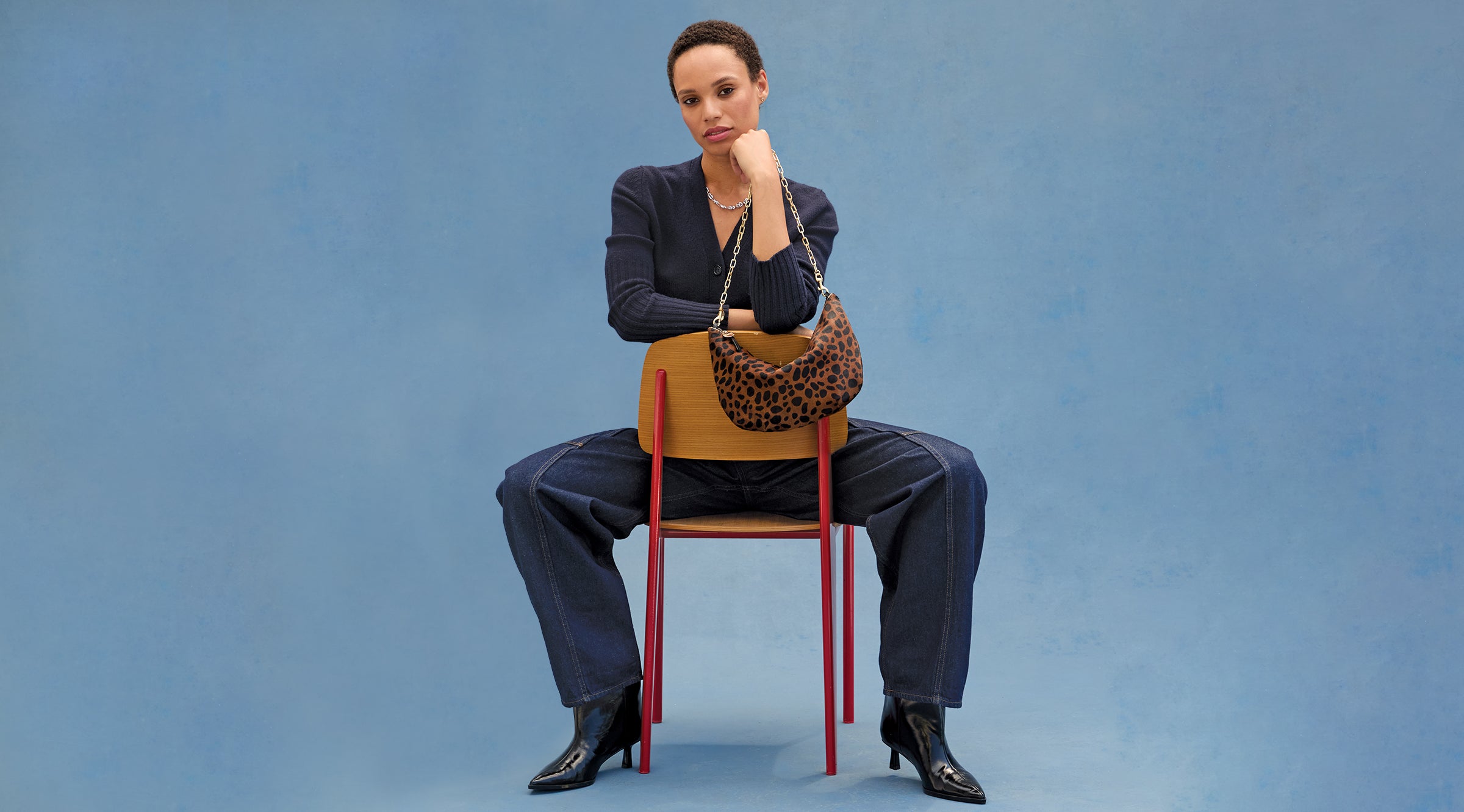 Model carrying the Leopard Hair-On Lune with Gold Oval Chain Shoulder Strap. 