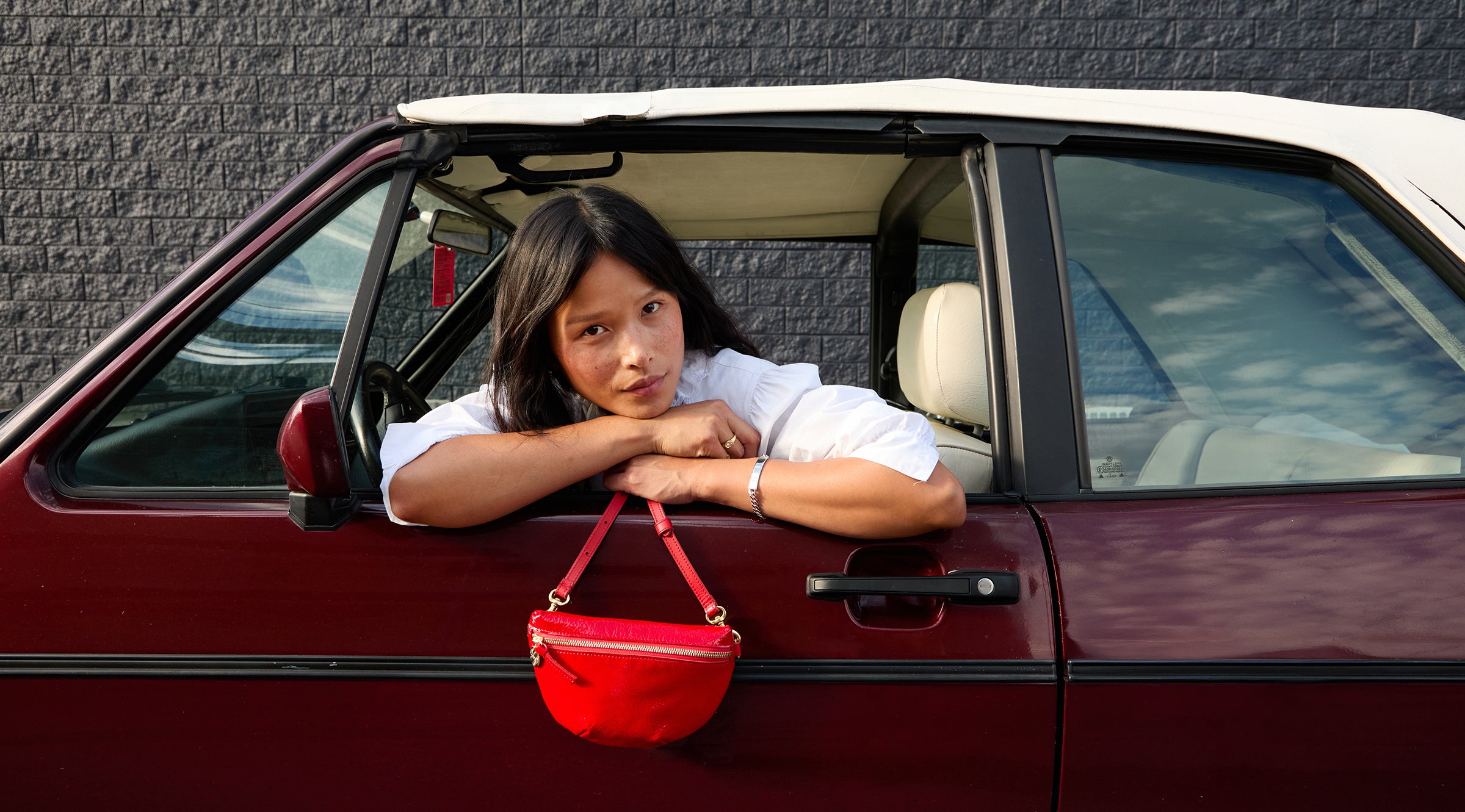 Model holding onto the Super Red Petite Fanny.