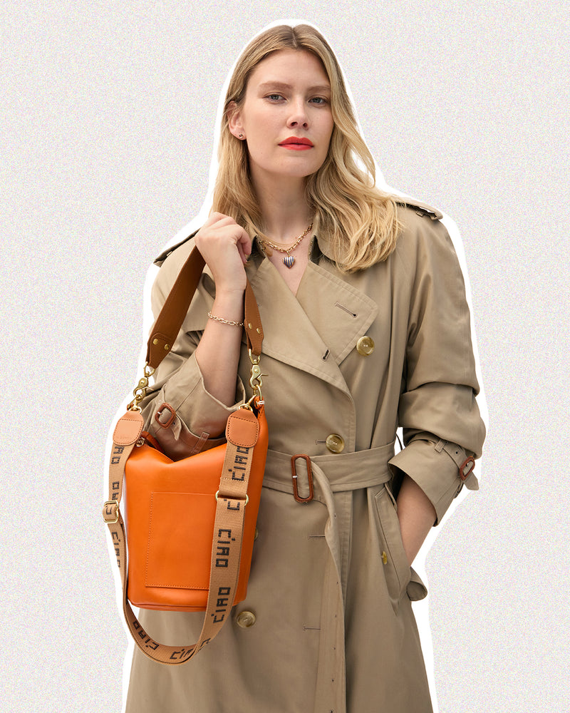 Model carrying the Petite Jeanne with Tan Ciao Adjustable Crossbody Strap.