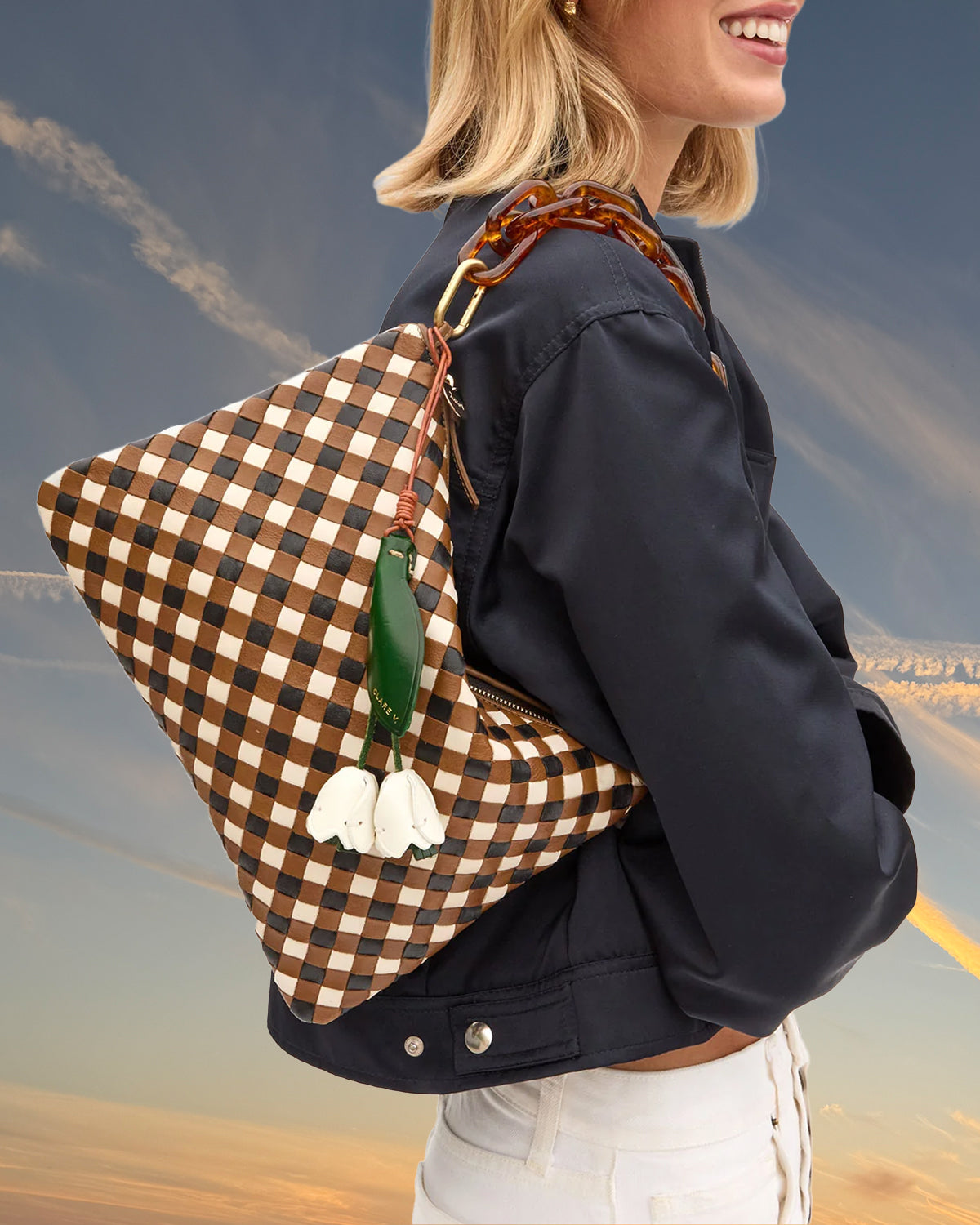 Model carrying the Flat Clutch with Tabs with La Fleur Fob attached.
