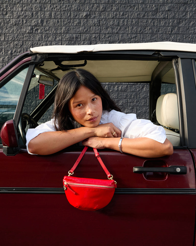 Model holding onto the Super Red Petite Fanny.