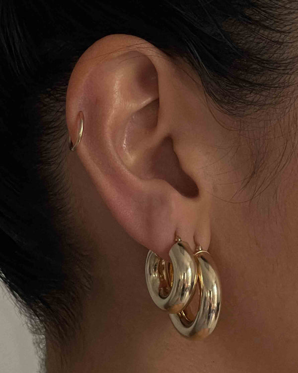 Kinn Studios Bold Hoops in the model's second piercing hole